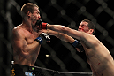 LAS VEGAS, NV - DECEMBER 30:  Donald Cerrone (left) and Nate Diaz (right) exchange punches during the UFC 141 event at the MGM Grand Garden Arena on December 30, 2011 in Las Vegas, Nevada.  (Photo by Josh Hedges/Zuffa LLC/Zuffa LLC via Getty Images) *** Local Caption *** Donald Cerrone; Nate Diaz