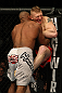 LAS VEGAS, NV - DECEMBER 30:  Alistair Overeem (white shorts) and Brock Lesnar (red shorts) struggle against the Octagon fence during the UFC 141 event at the MGM Grand Garden Arena on December 30, 2011 in Las Vegas, Nevada.  (Photo by Donald Miralle/Zuffa LLC/Zuffa LLC via Getty Images) *** Local Caption *** Alistair Overeem; Brock Lesnar