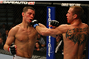 LAS VEGAS, NV - DECEMBER 30:  Donald Cerrone (right) and Nate Diaz (left) exchange blows during the UFC 141 event at the MGM Grand Garden Arena on December 30, 2011 in Las Vegas, Nevada.  (Photo by Donald Miralle/Zuffa LLC/Zuffa LLC via Getty Images) *** Local Caption *** Donald Cerrone; Nate Diaz