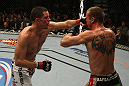 LAS VEGAS, NV - DECEMBER 30:  Nate Diaz (left) punches Donald Cerrone during the UFC 141 event at the MGM Grand Garden Arena on December 30, 2011 in Las Vegas, Nevada.  (Photo by Donald Miralle/Zuffa LLC/Zuffa LLC via Getty Images) *** Local Caption *** Nate Diaz; Donald Cerrone