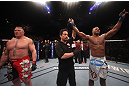 LAS VEGAS, NV - DECEMBER 30:  Alistair Overeem (right) is declared the winner in his fight over Brock Lesnar (left) during the UFC 141 event at the MGM Grand Garden Arena on December 30, 2011 in Las Vegas, Nevada.  (Photo by Donald Miralle/Zuffa LLC/Zuffa LLC via Getty Images) *** Local Caption *** Alistair Overeem; Brock Lesnar