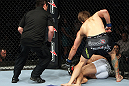 RIO DE JANEIRO, BRAZIL - JANUARY 14:  Mike Pyle punches down Ricardo Funch as Referee Mario Yamasaki watches in a welterweight bout during UFC 142 at HSBC Arena on January 14, 2012 in Rio de Janeiro, Brazil.  (Photo by Josh Hedges/Zuffa LLC/Zuffa LLC via Getty Images)