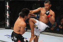 RIO DE JANEIRO, BRAZIL - JANUARY 14:  Yuri Alcantara knees Michihiro Omigawa in a featherweight bout during UFC 142 at HSBC Arena on January 14, 2012 in Rio de Janeiro, Brazil.  (Photo by Josh Hedges/Zuffa LLC/Zuffa LLC via Getty Images)
