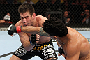 RIO DE JANEIRO, BRAZIL - JANUARY 14:  Thiago Tavares (R) punches Sam Stout (L) in a lightweight bout during UFC 142 at HSBC Arena on January 14, 2012 in Rio de Janeiro, Brazil.  (Photo by Josh Hedges/Zuffa LLC/Zuffa LLC via Getty Images)