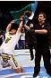 RIO DE JANEIRO, BRAZIL - JANUARY 14:  Referee Mario Yamasaki (R) holds up Thiago Tavares (L) hand as he celebrates after defeating Sam Stout (not pictured) in a lightweight bout during UFC 142 at HSBC Arena on January 14, 2012 in Rio de Janeiro, Brazil.  (Photo by Josh Hedges/Zuffa LLC/Zuffa LLC via Getty Images)