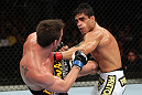 RIO DE JANEIRO, BRAZIL - JANUARY 14:  Thiago Tavares (R) punches Sam Stout (L) in a lightweight bout during UFC 142 at HSBC Arena on January 14, 2012 in Rio de Janeiro, Brazil.  (Photo by Josh Hedges/Zuffa LLC/Zuffa LLC via Getty Images)