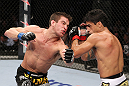 RIO DE JANEIRO, BRAZIL - JANUARY 14:  Thiago Tavares (R) and Sam Stout (L) exchange punches in a lightweight bout during UFC 142 at HSBC Arena on January 14, 2012 in Rio de Janeiro, Brazil.  (Photo by Josh Hedges/Zuffa LLC/Zuffa LLC via Getty Images)