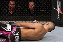 RIO DE JANEIRO, BRAZIL - JANUARY 14: Commentators Mike Goldberg (Top Right) and Joe Rogan (Top Left) look on as Terry Etim (Bottom) lays knocked out after being kicked by Edson Barboza (not pictured) with a spinning back kick in a lightweight bout during UFC 142 at HSBC Arena on January 14, 2012 in Rio de Janeiro, Brazil.  (Photo by Josh Hedges/Zuffa LLC/Zuffa LLC via Getty Images)