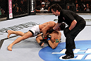 RIO DE JANEIRO, BRAZIL - JANUARY 14:  Erick Silva (Top) punches Carlo Prater as referee Mario Yamasaki (R) calls the welterweight bout during UFC 142 at HSBC Arena on January 14, 2012 in Rio de Janeiro, Brazil.  (Photo by Josh Hedges/Zuffa LLC/Zuffa LLC via Getty Images)
