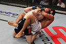 NASHVILLE, TN - JANUARY 20:  (R-L) Fabricio Camoes secures a rear choke submission against Tommy Hayden during the UFC on FX event at Bridgestone Arena on January 20, 2012 in Nashville, Tennessee.  (Photo by Josh Hedges/Zuffa LLC/Zuffa LLC via Getty Images)