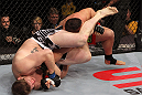 NASHVILLE, TN - JANUARY 20:  (L-R) Christian Morecraft attempts an arm bar submission against Pat Barry during the UFC on FX event at Bridgestone Arena on January 20, 2012 in Nashville, Tennessee.  (Photo by Josh Hedges/Zuffa LLC/Zuffa LLC via Getty Images)