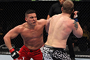 NASHVILLE, TN - JANUARY 20:  (L-R) Pat Barry delivers a punch against Christian Morecraft during the UFC on FX event at Bridgestone Arena on January 20, 2012 in Nashville, Tennessee.  (Photo by Josh Hedges/Zuffa LLC/Zuffa LLC via Getty Images)
