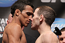 CHICAGO, IL - JANUARY 27:  (L-R) Featherweight opponents Charles Oliveira and Eric Wisely face off after weighing in during the UFC on FOX official weigh in at the Chicago Theatre on January 27, 2012 in Chicago, Illinois.  (Photo by Josh Hedges/Zuffa LLC/Zuffa LLC via Getty Images) *** Local Caption *** Charles Oliveira; Eric Wisely