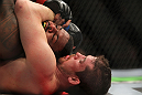CHICAGO, IL - JANUARY 28:  (R-L) Shane Roller attempts a rear choke submission against Michael Johnson during the UFC on FOX event at United Center on January 28, 2012 in Chicago, Illinois.  (Photo by Josh Hedges/Zuffa LLC/Zuffa LLC via Getty Images) *** Local Caption *** Michael Johnson; Shane Roller