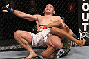 CHICAGO, IL - JANUARY 28:  Eric Wisely grimaces in pain as he is caught in a leg lock submission by Charles Oliveira during the UFC on FOX event at United Center on January 28, 2012 in Chicago, Illinois.  (Photo by Nick Laham/Zuffa LLC/Zuffa LLC via Getty Images) *** Local Caption *** Eric Wisely; Charles Oliveira