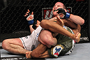CHICAGO, IL - JANUARY 28:  Eric Wisely grimaces in pain as he is caught in a leg lock submission by Charles Oliveira during the UFC on FOX event at United Center on January 28, 2012 in Chicago, Illinois.  (Photo by Nick Laham/Zuffa LLC/Zuffa LLC via Getty Images) *** Local Caption *** Eric Wisely; Charles Oliveira