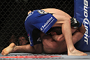 CHICAGO, IL - JANUARY 28:  Evan Dunham (blue shorts) attempts a guillotine choke submission against Nik Lentz during the UFC on FOX event at United Center on January 28, 2012 in Chicago, Illinois.  (Photo by Josh Hedges/Zuffa LLC/Zuffa LLC via Getty Images) *** Local Caption *** Evan Dunham; Nik Lentz