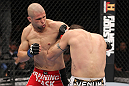 LAS VEGAS, NV - FEBRUARY 04:  Chris Cope (red shorts) punches Matt Brown during the UFC 143 event at Mandalay Bay Events Center on February 4, 2012 in Las Vegas, Nevada.  (Photo by Nick Laham/Zuffa LLC/Zuffa LLC via Getty Images) *** Local Caption *** Chris Cope