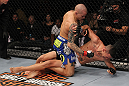LAS VEGAS, NV - FEBRUARY 04:  Dustin Poirier (blue shorts) delivers punches to Max Holloway from the mount during the UFC 143 event at Mandalay Bay Events Center on February 4, 2012 in Las Vegas, Nevada.  (Photo by Nick Laham/Zuffa LLC/Zuffa LLC via Getty Images) *** Local Caption *** Dustin Poirier; Max Holloway