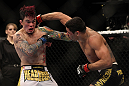 LAS VEGAS, NV - FEBRUARY 04:  Renan Barao (right) punches Scott Jorgensen during the UFC 143 event at Mandalay Bay Events Center on February 4, 2012 in Las Vegas, Nevada.  (Photo by Josh Hedges/Zuffa LLC/Zuffa LLC via Getty Images) *** Local Caption *** Renan Barao; Scott Jorgensen