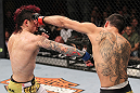 LAS VEGAS, NV - FEBRUARY 04:  Renan Barao (right) punches Scott Jorgensen during the UFC 143 event at Mandalay Bay Events Center on February 4, 2012 in Las Vegas, Nevada.  (Photo by Nick Laham/Zuffa LLC/Zuffa LLC via Getty Images) *** Local Caption *** Renan Barao; Scott Jorgensen
