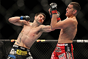 LAS VEGAS - FEBRUARY 04:  Carlos Condit (left) punches Nick Diaz during the UFC 143 event at Mandalay Bay Events Center on February 4, 2012 in Las Vegas, Nevada.  (Photo by Josh Hedges/Zuffa LLC/Zuffa LLC via Getty Images) *** Local Caption *** Carlos Condit; Nick Diaz