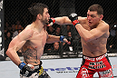 LAS VEGAS - FEBRUARY 04:  (R-L) Nick Diaz punches Carlos Condit during the UFC 143 event at Mandalay Bay Events Center on February 4, 2012 in Las Vegas, Nevada.  (Photo by Nick Laham/Zuffa LLC/Zuffa LLC via Getty Images) *** Local Caption *** Carlos Condit; Nick Diaz
