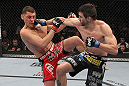 LAS VEGAS - FEBRUARY 04:  (R-L) Carlos Condit punches Nick Diaz during the UFC 143 event at Mandalay Bay Events Center on February 4, 2012 in Las Vegas, Nevada.  (Photo by Nick Laham/Zuffa LLC/Zuffa LLC via Getty Images) *** Local Caption *** Carlos Condit; Nick Diaz