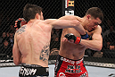 LAS VEGAS - FEBRUARY 04:  Carlos Condit (left) punches Nick Diaz during the UFC 143 event at Mandalay Bay Events Center on February 4, 2012 in Las Vegas, Nevada.  (Photo by Nick Laham/Zuffa LLC/Zuffa LLC via Getty Images) *** Local Caption *** Carlos Condit; Nick Diaz