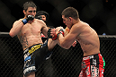 LAS VEGAS - FEBRUARY 04:  Carlos Condit (left) kicks Nick Diaz during the UFC 143 event at Mandalay Bay Events Center on February 4, 2012 in Las Vegas, Nevada.  (Photo by Josh Hedges/Zuffa LLC/Zuffa LLC via Getty Images) *** Local Caption *** Carlos Condit; Nick Diaz