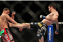 LAS VEGAS - FEBRUARY 04:  (R-L) Carlos Condit kicks Nick Diaz during the UFC 143 event at Mandalay Bay Events Center on February 4, 2012 in Las Vegas, Nevada.  (Photo by Josh Hedges/Zuffa LLC/Zuffa LLC via Getty Images) *** Local Caption *** Carlos Condit; Nick Diaz