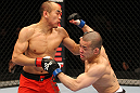 SAITAMA, JAPAN - FEBRUARY 26:  (R-L) Issei Tamura delivers a punch that knocks down Tiequan Zhang during the UFC 144 event at Saitama Super Arena on February 26, 2012 in Saitama, Japan.  (Photo by Al Bello/Zuffa LLC/Zuffa LLC via Getty Images) *** Local Caption *** Tiequan Zhang; Issei Tamura