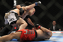 SAITAMA, JAPAN - FEBRUARY 26:  (L-R) Issei Tamura knocks out Tiequan Zhang with a punch on the ground during the UFC 144 event at Saitama Super Arena on February 26, 2012 in Saitama, Japan.  (Photo by Josh Hedges/Zuffa LLC/Zuffa LLC via Getty Images) *** Local Caption *** Tiequan Zhang; Issei Tamura
