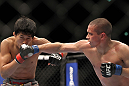 SAITAMA, JAPAN - FEBRUARY 26:  (R-L) Chris Cariaso punches Takeya Mizugaki during the UFC 144 event at Saitama Super Arena on February 26, 2012 in Saitama, Japan.  (Photo by Josh Hedges/Zuffa LLC/Zuffa LLC via Getty Images) *** Local Caption *** Takeya Mizugaki; Chris Cariaso