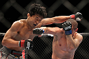 SAITAMA, JAPAN - FEBRUARY 26:  (R-L) Chris Cariaso punches Takeya Mizugaki during the UFC 144 event at Saitama Super Arena on February 26, 2012 in Saitama, Japan.  (Photo by Josh Hedges/Zuffa LLC/Zuffa LLC via Getty Images) *** Local Caption *** Takeya Mizugaki; Chris Cariaso