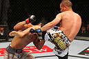 SAITAMA, JAPAN - FEBRUARY 26:  (R-L) Chris Cariaso kicks Takeya Mizugaki during the UFC 144 event at Saitama Super Arena on February 26, 2012 in Saitama, Japan.  (Photo by Al Bello/Zuffa LLC/Zuffa LLC via Getty Images) *** Local Caption *** Takeya Mizugaki; Chris Cariaso