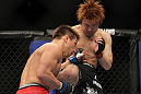 SAITAMA, JAPAN - FEBRUARY 26:  (R-L) Takanori Gomi and Eiji Mitsuoka trade strikes during the UFC 144 event at Saitama Super Arena on February 26, 2012 in Saitama, Japan.  (Photo by Josh Hedges/Zuffa LLC/Zuffa LLC via Getty Images) *** Local Caption *** Takanori Gomi; Eiji Mitsuoka