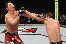 SYDNEY, AUSTRALIA - MARCH 03:  (R-L) Cole Miller punches Steven Siler in a featherweight bout during the UFC on FX event at Allphones Arena on March 3, 2012 in Sydney, Australia.  (Photo by Josh Hedges/Zuffa LLC/Zuffa LLC via Getty Images) *** Local Caption *** Cole Miller; Steven Siler