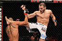 STOCKHOLM, SWEDEN - APRIL 14:  (R-L) Eric Wisely kicks Jason Young during their featherweight bout at the UFC on Fuel TV event at Ericsson Globe on April 14, 2012 in Stockholm, Sweden.  (Photo by Josh Hedges/Zuffa LLC/Zuffa LLC via Getty Images)