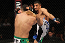 STOCKHOLM, SWEDEN - APRIL 14:  (R-L) Yoislandy Izquierdo kicks Reza Madadi during their lightweight bout at the UFC on Fuel TV event at Ericsson Globe on April 14, 2012 in Stockholm, Sweden.  (Photo by Josh Hedges/Zuffa LLC/Zuffa LLC via Getty Images)