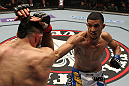 STOCKHOLM, SWEDEN - APRIL 14:  (R-L) Yoislandy Izquierdo punches Reza Madadi during their lightweight bout at the UFC on Fuel TV event at Ericsson Globe on April 14, 2012 in Stockholm, Sweden.  (Photo by Josh Hedges/Zuffa LLC/Zuffa LLC via Getty Images)