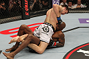 STOCKHOLM, SWEDEN - APRIL 14:  Magnus Cedenblad (white shorts) punches down at Francis Carmont during their middleweight bout at the UFC on Fuel TV event at Ericsson Globe on April 14, 2012 in Stockholm, Sweden.  (Photo by Josh Hedges/Zuffa LLC/Zuffa LLC via Getty Images)