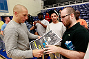 ATLANTA, GA - APRIL 19:  Georges St-Pierre of Canada signs autographs during UFC 145 open workouts at GSU Sports Arena on April 19, 2012 in Atlanta, Georgia.  (Photo by Kevin C. Cox/Zuffa LLC/Zuffa LLC via Getty Images)