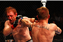 ATLANTA, GA - APRIL 21:  John Alessio (R) hits Mark Bocek during their lightweight bout for UFC 145 at Philips Arena on April 21, 2012 in Atlanta, Georgia.  (Photo by Al Bello/Zuffa LLC/Zuffa LLC via Getty Images)