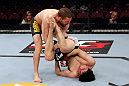 EAST RUTHERFORD, NJ - MAY 05:  Nick Denis slams Roland Delorme to the ground during thier Bantamweight bout at Izod Center on May 5, 2012 in East Rutherford, New Jersey.  (Photo by Josh Hedges/Zuffa LLC/Zuffa LLC via Getty Images)