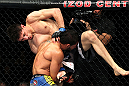 EAST RUTHERFORD, NJ - MAY 05:  Dennis Bermudez throws Pablo Garza into the cage during thier Bantamweight bout at Izod Center on May 5, 2012 in East Rutherford, New Jersey.  (Photo by Josh Hedges/Zuffa LLC/Zuffa LLC via Getty Images)
