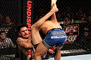 EAST RUTHERFORD, NJ - MAY 05:  Dennis Bermudez slams Pablo Garza to the ground during thier Bantamweight bout at Izod Center on May 5, 2012 in East Rutherford, New Jersey.  (Photo by Josh Hedges/Zuffa LLC/Zuffa LLC via Getty Images)