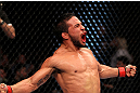 EAST RUTHERFORD, NJ - MAY 05:  Dennis Bermudez celebrates after defeating Pablo Garza in thier Bantamweight bout at Izod Center on May 5, 2012 in East Rutherford, New Jersey.  (Photo by Josh Hedges/Zuffa LLC/Zuffa LLC via Getty Images)