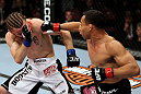 EAST RUTHERFORD, NJ - MAY 05:  John Dodson (R) punches Timothy Elliott (L) during thier Flyweight bout at Izod Center on May 5, 2012 in East Rutherford, New Jersey.  (Photo by Josh Hedges/Zuffa LLC/Zuffa LLC via Getty Images)