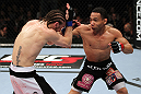 EAST RUTHERFORD, NJ - MAY 05:  John Dodson (R) punches Timothy Elliott (L) during thier Flyweight bout at Izod Center on May 5, 2012 in East Rutherford, New Jersey.  (Photo by Josh Hedges/Zuffa LLC/Zuffa LLC via Getty Images)